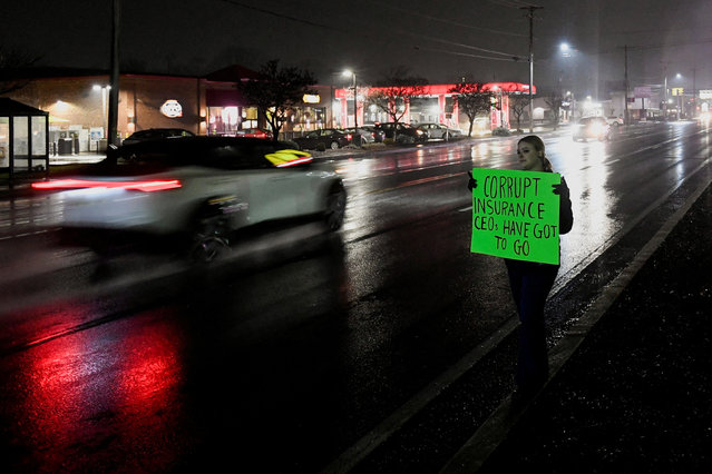 A person holds a sign while standing on the roadside near the McDonald's restaurant where a suspect in the killing of the CEO of UnitedHealthcare, Brian Thompson, identified as Luigi Mangione, 26, was arrested, in Altoona, Pennsylvania on December 10, 2024. (Photo by Matthew Hatcher/Reuters)