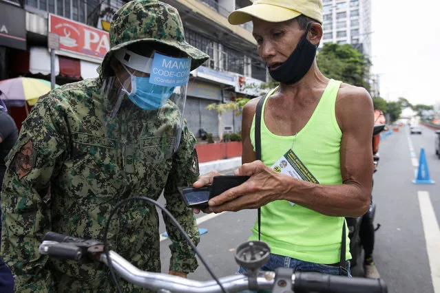 A man is questioned by police at a checkpoint in Manila, Philippines, 01 April 2020. Philippines now has 2,311 coronavirus cases, 96 deaths and 50 recovered. (Photo by Mark R. Cristino/EPA/EFE)