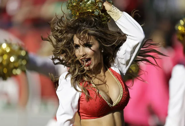 A San Francisco 49ers cheerleader performs during the fourth quarter of an NFL football game against the Arizona Cardinals in San Francisco, Sunday, October 13, 2013. (Photo by Ben Margot/AP Photo)