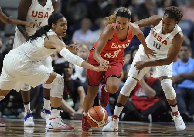 United States' Maya Moore, left, and Tamika Catchings, right, pressure Canada's Miah-Marie Langlois, center, during the first half of an exhibition basketball game, Friday, July 29, 2016, in Bridgeport, Conn. (Photo by Jessica Hill/AP Photo)