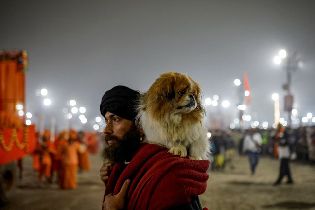 A dog rests on the shoulder of a sadhu or a Hindu holy man during the “Maha Kumbh Mela”, or the Great Pitcher Festival, in Prayagraj, India, on January 14, 2025. (Photo by Anushree Fadnavis/Reuters)