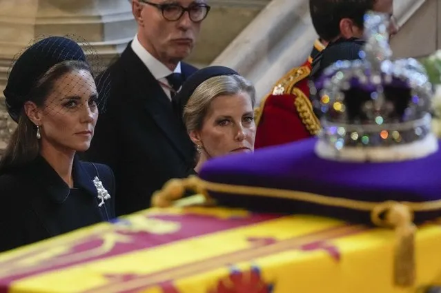 Britain's Kate, Princess of Wales, left, and Sophie, Countess of Wessex watch the coffin of Queen Elizabeth arrive in Westminster Hall, London, Wednesday, September 14, 2022. The Queen will lie in state in Westminster Hall for four full days before her funeral on Monday Sept. 19. (Gregorio Borgia/Pool via AP Photo)