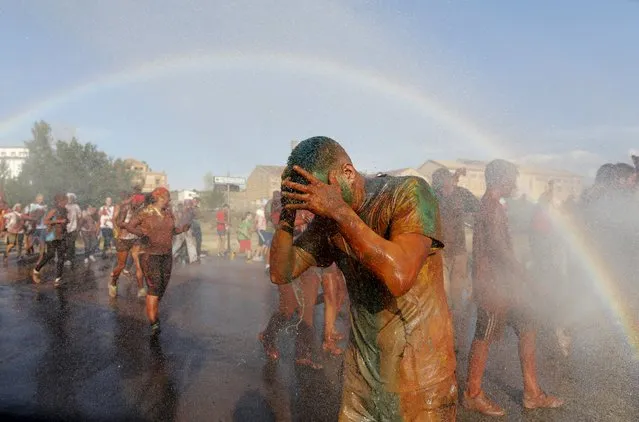 A rainbow forms as a reveller covered in paint reacts as he is sprayed with water, during the annual Cascamorras festival in Guadix, southern Spain September 9, 2015. (Photo by Marcelo del Pozo/Reuters)