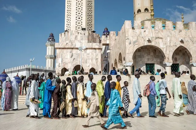Pilgrims of the Mouride Brotherhood ait in lines to enter the Grand Mosque during the Grand Magal of Mourides' annual muslim pilgrimage in Touba on September 15, 2022. (Photo by Muhamadou Bittaye/AFP Photo)