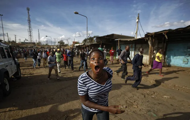 An opposition protester reacts as she hears rumours that opposition leader Raila Odinga was coming to visit them, causing thousands to turn out on the streets but which later turned out to be untrue, in the Kawangware area of Nairobi, Kenya, Saturday, October 28, 2017. (Photo by Ben Curtis/AP Photo)