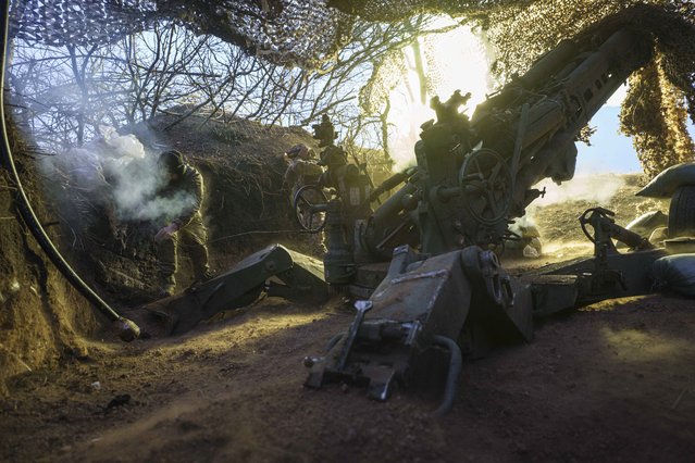 Ukrainian servicemen of the 148th artillery brigade fire a M777 howitzer towards Russian positions at the frontline on Velyka Novosilka direction, Donetsk region, Ukraine, January 26, 2025. (Photo by Evgeniy Maloletka/AP Photo)