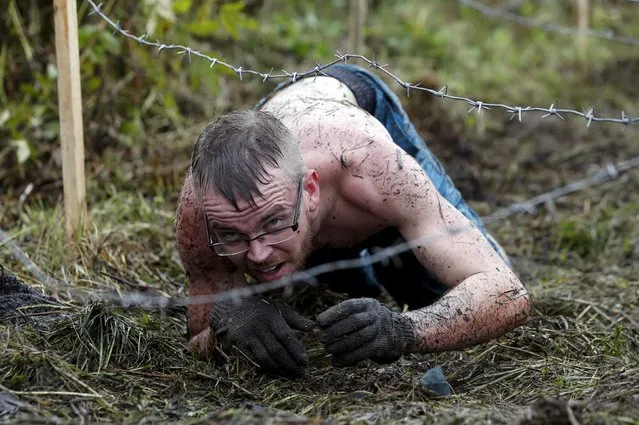 A man takes part in an extreme run competition in Zhodino, east of Minsk, September 26, 2015. (Photo by Vasily Fedosenko/Reuters)