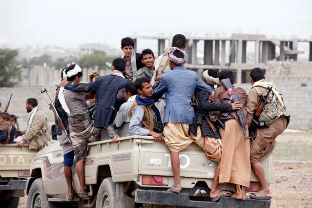 Tribesmen loyal to the Houthi movement ride on the back of a truck as they leave a tribal gathering they held to show support to a political council formed by the movement and the General People's Congress party to unilaterally rule Yemen by both groups in Sanaa, August 14, 2016. (Photo by Khaled Abdullah/Reuters)