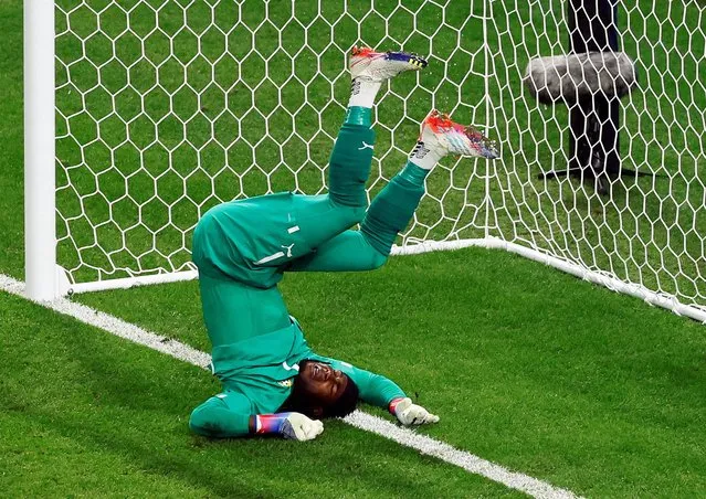 Ghana's goalkeeper #01 Lawrence Ati Zigi falls as he makes a save during the Qatar 2022 World Cup Group H football match between Ghana and Uruguay at the Al-Janoub Stadium in Al-Wakrah, south of Doha on December 2, 2022. (Photo by Albert Gea/Reuters)