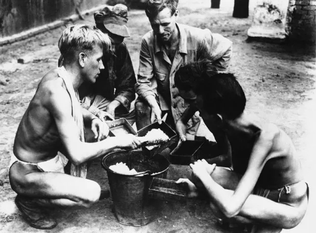 In Tangoon Prison, the staple, the only diet was rice. In their habitual costume, allied prisoners of war have their last meal before being taken to base camp and freedom on May 26, 1945. Their sparse clothing, all they had. (Photo by AP Photo)