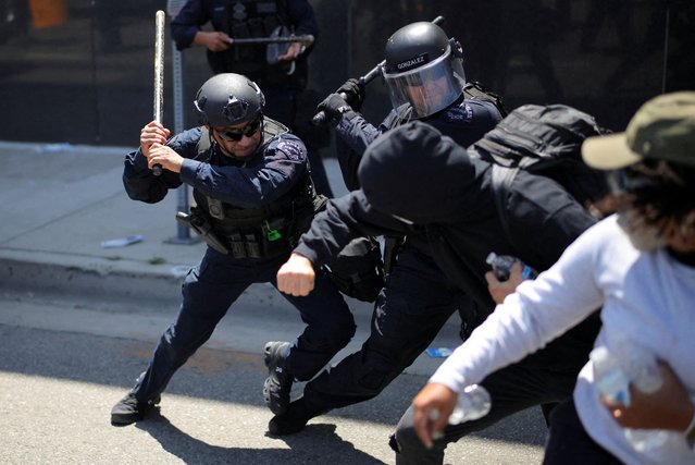 Members of the Los Angeles Metro Police clash with demonstrators during a protest against federal immigration sweeps in downtown Los Angeles on June 8, 2025. (Photo by Daniel Cole/Reuters)