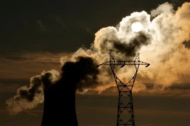 The cooling tower of Bouchain power station, a 585-megawatt (MW) gas-fired power plant is seen during sunset in Bouchain, northern France, France on December 12, 2022. (Photo by Pascal Rossignol/Reuters)