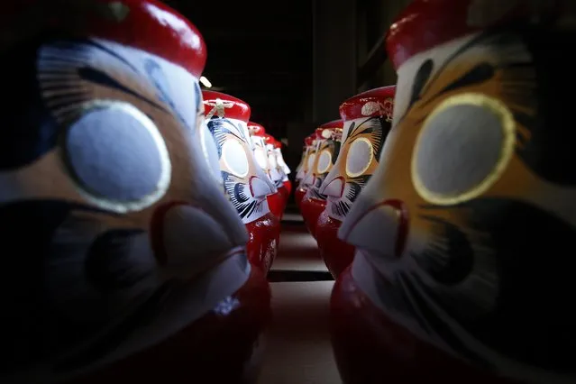 Daruma dolls, which are believed to bring good luck, are stored at a studio of Daruma doll shop  “Daimonya” in Takasaki, northwest of Tokyo November 23, 2014. (Photo by Yuya Shino/Reuters)