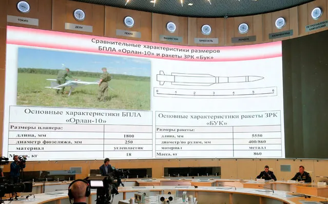 A screen shows the specifications of the “Orlan-10” unmanned aerial vehicle (L) and the “Buk” missile system during a news conference, dedicated to the crash of the Malaysia Airlines Boeing 777 plane operating flight MH17, in Moscow, Russia, September 26, 2016. (Photo by Maxim Zmeyev/Reuters)