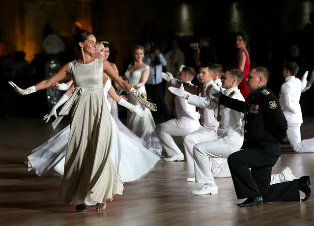 Couples take part in the 7th Sevastopol Grand Charity Officers' Ball held in Mikhailovskaya Coastal Battery Square to mark this year's 75th anniversary of the victory in World War II and Russian composer Pyotr Tchaikovsky's 180th birth anniversary in Sevastopol, Russia on September 27, 2020. (Photo by Sergei Malgavko/TASS)