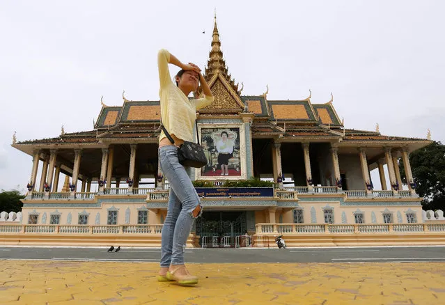 A Chinese tourist visits in front of the Royal Palace in Phnom Penh, Cambodia, October 3, 2016. (Photo by Samrang Pring/Reuters)