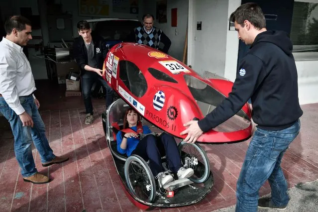 Students prepare to try their electric car prototype called Pyrforos at the  Polytechnic School of Athens campus on March 6, 2018. The car designed in Athens has attracted the interest of the American manufacturer Tesla, who has debauched Greek engineers and will establish in Greece a research center: a symbolic innovation in a country stricken by almost 10 years of deep economic crisis. This vehicle has already been awarded several times in recent years in Shell's European Eco-Marathon competition, which aims to travel the longest distance with the least energy possible. Tesla announced at the end of February that it would establish near Athens a center of research and development of its engines. An investment of 750,000 euros considered “important” for the country, which emerges from the tunnel of recession. (Photo by Louisa Gouliamaki/AFP Photo)