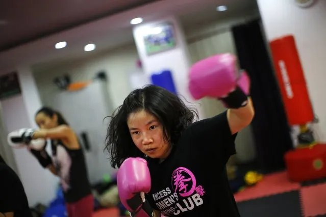 A woman attends a boxing class at Princess Women's Boxing Club in Shanghai December 3, 2014. (Photo by Carlos Barria/Reuters)