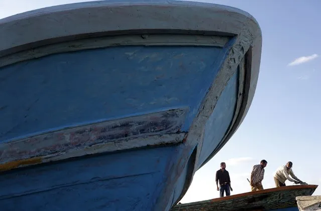 Fishermen repair boats at the entrance to the fishermen's village in the El Max area in the Mediterranean city of Alexandria September 12, 2014. (Photo by Amr Abdallah Dalsh/Reuters)