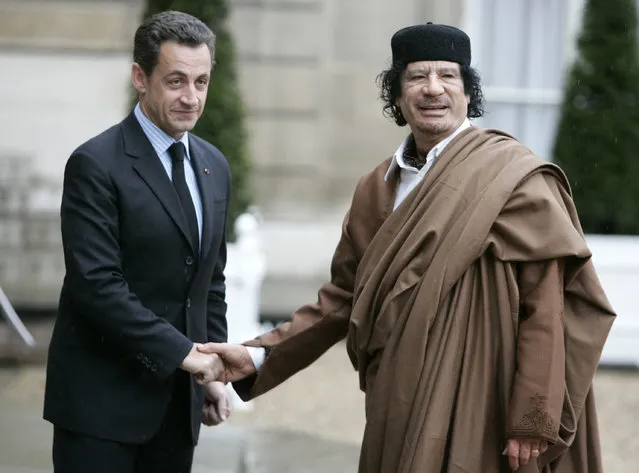 In this December 10 2007 file photo, French President Nicolas Sarkozy, left, greets Libyan leader Col. Moammar Gadhafi upon his arrival at the Elysee Palace, in Paris. Former French President Nicolas Sarkozy was placed in custody on Tuesday March 20, 2018 as part of an investigation that he received millions of euros in illegal financing from the regime of the late Libyan leader Moammar Gadhafi. (Photo by Francois Mori/AP Photo)