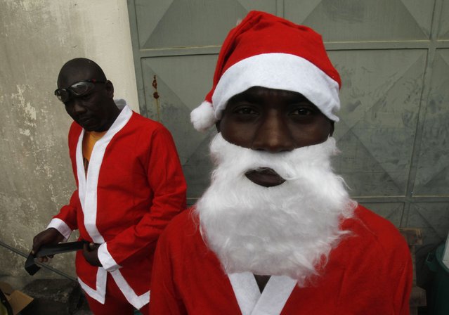 Jumia delivery men dressed as Santa Claus at the yard of Jumia office in Abidjan, Ivory Coast December 18, 2014. Jumia is an African online retailer which offers goods ranging from electronics to kids' items. (Photo by Luc Gnago/Reuters)