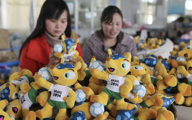 Employees inspect factory in Ganyu, China, the mass production of dolls Fuleco, official mascot of the 2014 World Cup in Brazil, on April 26, 2013. (Photo by Reuters/China Daily)
