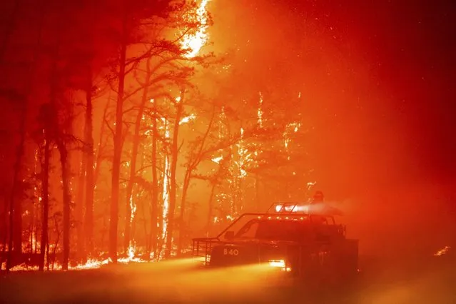 In this photo provided by the New Jersey Department of Environmental Protection, a massive 2,500-acre forest fire burns in Ocean County, N.J., early Wednesday, April 12, 2023, as firefighters battle the blaze. The fire started late Tuesday, April 11, and is burning across some 2,500 acres (about 1,000 hectares). (Photo by New Jersey Department of Environmental Protection via AP Photo)