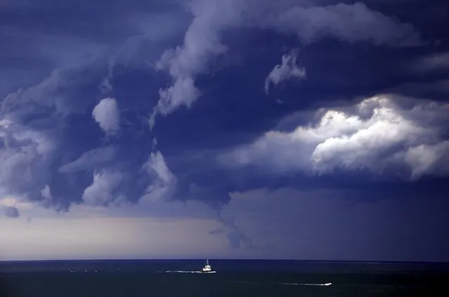 Boats head into shore as storm clouds move along the coast towards the city of Sydney, Australia, November 6, 2015. (Photo by David Gray/Reuters)