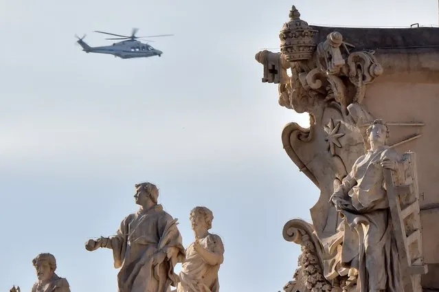 An helicopter of the Italian police in seen in the sky over statues of the Vatican, on November 19, 2015 in Rome. Italy has increased security at its historic monuments in the Vatican, Rome and Milan after a warning from the FBI of possible jihadist attacks, media reports said yesterday. (Photo by Giuseppe Cacace/AFP Photo)