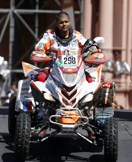 Yamaha rider Paulo Guardia Mancilla of Chile rides his quad during the departure ceremony for Dakar Rally 2015 in front of the Casa Rosada Presidential Palace in Buenos Aires January 3, 2015. (Photo by Marcos Brindicci/Reuters)