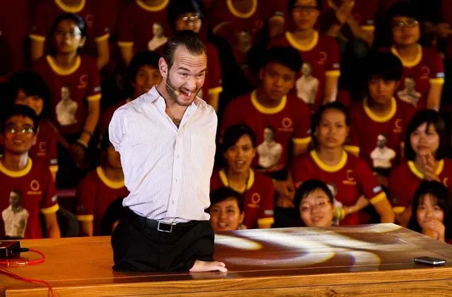 Nick Vujicic, a Serbian Australian evangelist who was born with no limbs, speaks to about 25,000 students and young people at My Dinh national stadium in Hanoi, Vietnam, on May 23, 2013. In a talk laced with jokes, platitudes and attempts at Vietnamese, he spoke out against bullying and drinking; on the need for forgiveness and hope; and respect for family. (Photo by Na Son Nguyen/Associated Press)