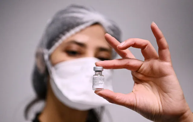 A health worker displays a dose of the Pfizer-BioNTech COVID-19 vaccine at Robert Ballanger hospita in Aulnay-sous-Bois, north of Paris, Wednesday, January 6, 2021. Amid public outcry, France's health minister promised Tuesday an “exponential” acceleration of his country's shockingly slow coronavirus vaccination process. (Photo by Christophe Archambault/Pool Photo via AP Photo)