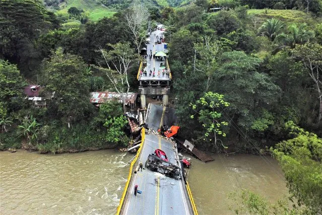 Aerial view of the Alambrado bridge after it collapsed in Caicedonia, Valle del Cauca deparment, Colombia on April 13, 2023. Colombian authorities are investigating the causes of the collapse that left two policemen dead and do not rule out an attack, informed Thursday the National Infrastructure Agency (ANI). (Photo by Edwin Rodriguez Pipicano/AFP Phoot)