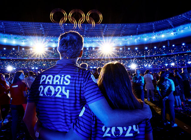 Athletes and the Olympic rings are pictured during the closing ceremony of the Paris 2024 Olympic Games at the Stade de France, in Saint-Denis, in the outskirts of Paris, on August 11, 2024. (Photo by Gonzalo Fuentes/Reuters)