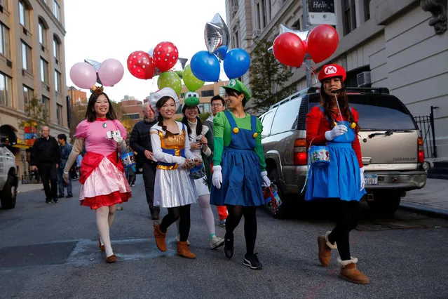 Women dressed as characters from Super Mario arrive to participate in the Greenwich Village Halloween Parade in Manhattan, New York, U.S., October 31, 2016. (Photo by Andrew Kelly/Reuters)