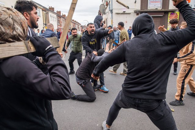 Residents surround a suspected far-right rioter while one man seeks to calm the group in Middlesbrough, UK on August 4, 2024, where rioters damaged properties and businesses.. (Photo by Gary Calton/The Observer)