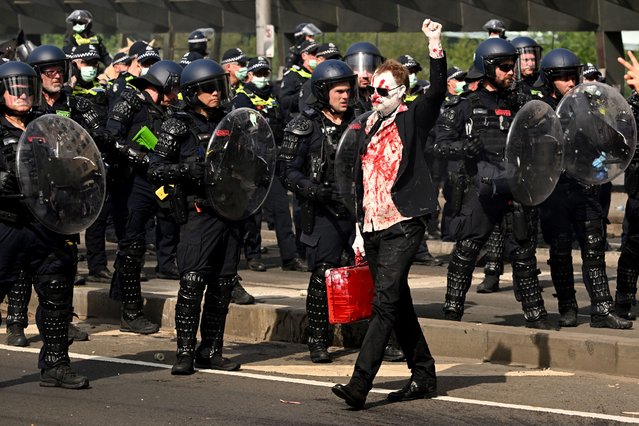 A protester confronts police outside the Land Forces 2024 arms fair in Melbourne on September 11, 2024. (Photo by William West/AFP Photo)