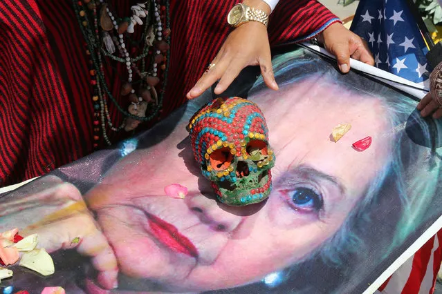Peruvian shamans holding a poster of U.S. Democratic presidential candidate Hillary Clinton perform a ritual of predictions ahead of the U.S. presidential elections, at Lima, Peru November 7, 2016. (Photo by Mariana Bazo/Reuters)