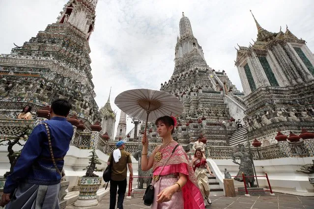 Chinese tourists dressed in Thai traditional costumes rented from a clothing rental visit Wat Arun or Temple of Dawn in Bangkok, Thailand, 22 May 2023. According to Deputy Government Spokesperson Traisulee Traisaranakul, 9.47 million foreign tourists visited Thailand since January 2023 generating about 391 billion Thai baht (11.36 billion US dollars or 10.50 billion euro) in revenue. Further growth is projected in Thailand's tourism industry with an expected increase of seven million Chinese tourists arrivals this year. (Photo by Rungroj Yongrit/EPA/EFE/Rex Features/Shutterstock)