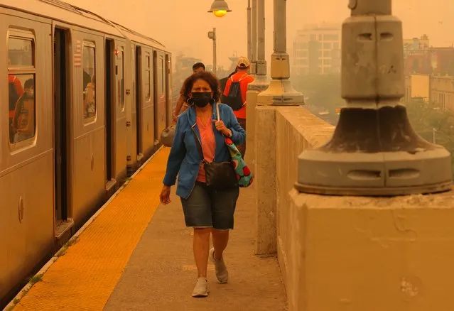 People wear face masks to protect themselves during bad air quality as smoke of Canadian wildfires brought in by wind in New York, United States on June 7, 2023. New York City has the worst air in the world according to IQAir, a Swiss air monitoring company as Canadian wildfire smoke continues to filter into the city. Authorities urge people to wear masks, all outdoor activities for school children were canceled as well as regular baseball game at Yankee stadium between Yankees and White Sox. Many activities in city parks were canceled as well. (Photo by Selcuk Acar/Anadolu Agency via Getty Images)