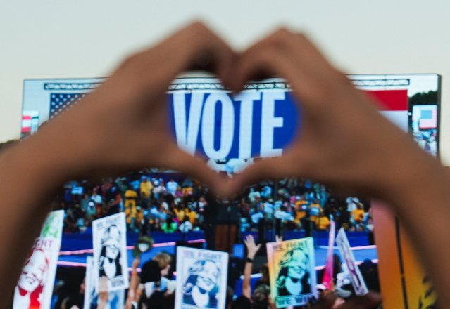 A supporter holds up their hands in heart shape as they attend Democratic presidential nominee U.S. Vice President Kamala Harris' campaign rally in Atlanta, Georgia, U.S., October 24, 2024. (Photo by Megan Varner/Reuters)
