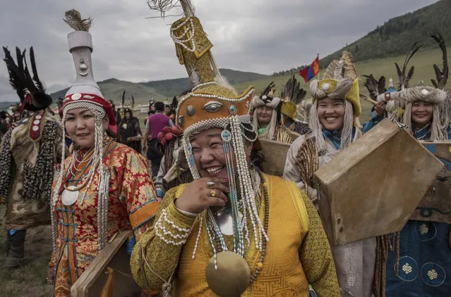 Mongolian Shamans or Buu, gather before a fire ritual meant to summon spirits to mark the period of the Summer Solstice on June 23, 2018 outside Ulaanbaatar, Mongolia. (Photo by Kevin Frayer/Getty Images)