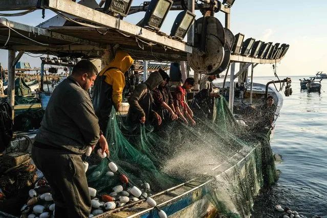 Palestinian fishermen work at the port in Gaza City on June 15, 2023. (Photo by Ronaldo Schemidt/AFP Photo)