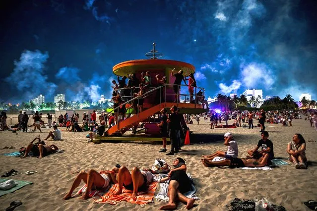 People gather to watch Independence Day fireworks on South Beach in Miami Beach, Florida on July 4, 2023. (Photo by Chandan Khanna/AFP Photo)