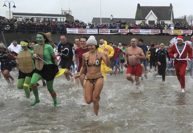 Swimmers in fancy dress participate in the New Year's Day swim at Saundersfoot in south Wales, Britain January 1, 2016. (Photo by Rebecca Naden/Reuters)