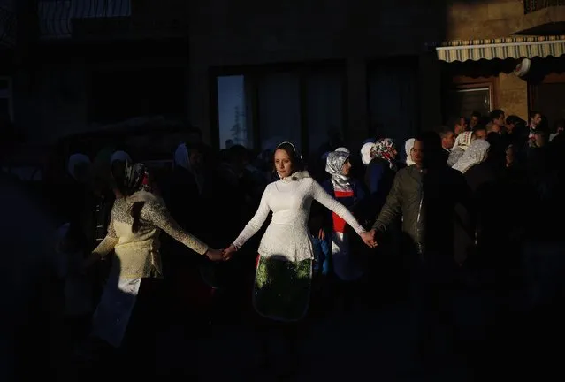 Women dance during the wedding ceremony of Bulgarian Muslims Fikrie Bindzheva and Azim Liumankov in the village of Ribnovo, in the Rhodope Mountains, February 14, 2015. (Photo by Stoyan Nenov/Reuters)