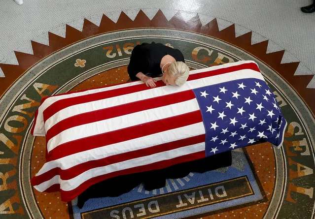 Cindy McCain, wife of, Sen. John McCain, R-Ariz. lays her head on casket during a memorial service at the Arizona Capitol on Wednesday, August 29, 2018, in Phoenix. (Photo by Ross D. Franklin/AP Photo/Pool)