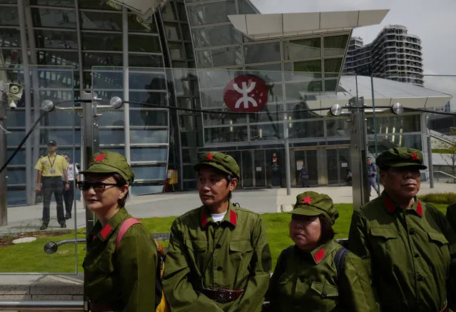 Protesters dress as People's Liberation Army (PLA) during a protest outside the Western Kowloon Station against the opening ceremony of the Hong Kong Express Rail Link in Hong Kong, Saturday, September 22, 2018. Hong Kong has opened a new high-speed rail link to inland China that will vastly decrease travel times but which also raises concerns about Beijing's creeping influence over the semi-autonomous Chinese region. (Photo by Vincent Yu/AP Photo)