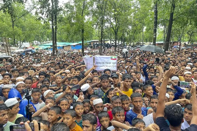 Rohingya refugees gather for a rally marking the 6th anniversary of genocide day, in Ukhia on August 25, 2023. Thousands of Rohingya refugees on Friday rallied in Bangladesh camps to mark the sixth anniversary of “genocide day”, demanding their secured and dignified return to Myanmar. More than 7,00,000 Rohingya Muslims fled from Myanmar to Bangladesh to escape military crackdown in August, 2017, which is now a subject to genocide investigation at the International Criminal Court. (Photo by Tanbir Miraj/AFP Photo)