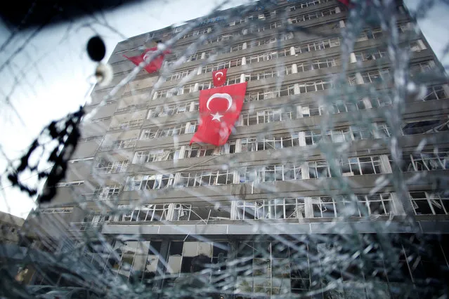 The Ankara police headquarters is seen through a car's broken window caused by fighting during a coup attempt in Ankara, Turkey, July 19, 2016. (Photo by Baz Ratner/Reuters)